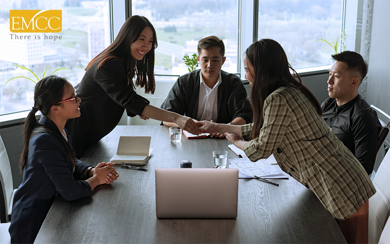 two women shaking hands in a meeting room