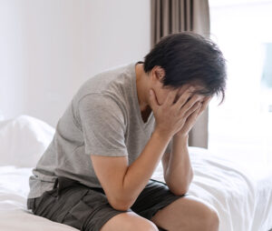 Man hiding face after relationship conflict.