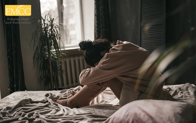Person feeling depressed and stressed sitting in the dark room