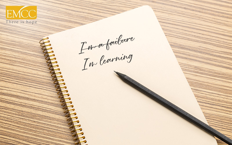 Notebook with self-compassion quotes for managing depression.