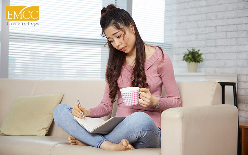 Woman practicing self-compassion through journaling for mental health.