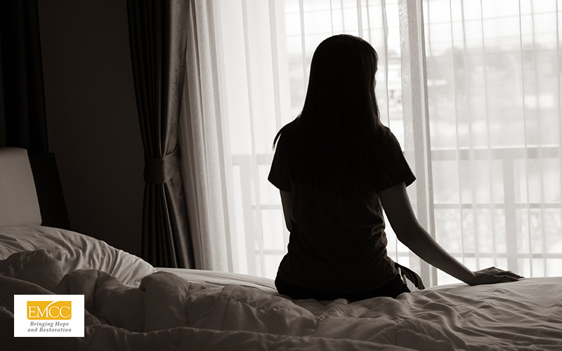 Woman sitting alone, potentially struggling with depression